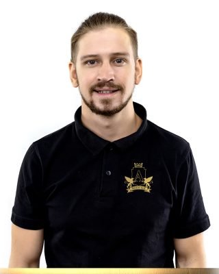 young handsome man in black polo shirt smiling friendly looking at camera standing over white background